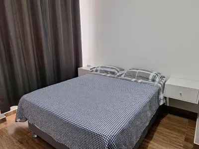 a bedroom with a bed with a black and white comforter at Dormitorio matrimonial 02 in Lima