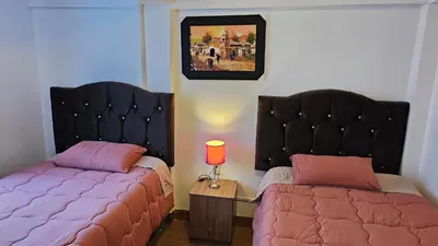 two beds sitting next to each other in a bedroom at Casa Independiente cerca al centro historico en Primer Piso - Los Profesionales in Cusco