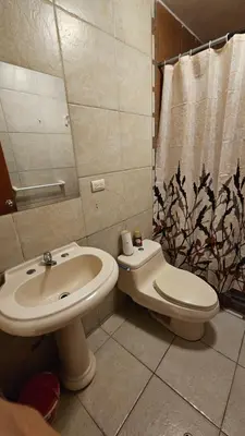 a bathroom with a sink and a toilet and a shower curtain at Casa Independiente cerca al centro historico en Primer Piso - Los Profesionales in Cusco