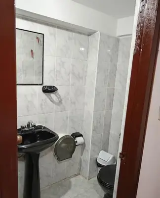 a bathroom with a sink and a toilet at Tierra Mágica Hostal in Machu Picchu