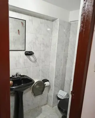 a bathroom with a sink and a toilet at Tierra Mágica Hostal in Machu Picchu