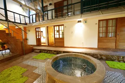 a large room with a tub in the middle of a building at Tandapata Boutique Hotel in Cusco