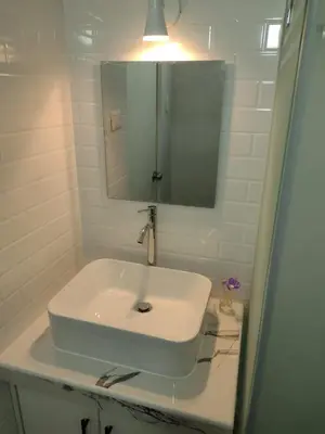 a bathroom with a white sink and a mirror at Bella vista al mar de Lima - Miraflores in Lima