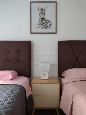 a bedroom with two beds and a zebra picture on the wall at Bella vista al mar de Lima - Miraflores in Lima