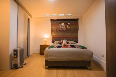 a bedroom with a bed with a stuffed animal on it at RumiUma Boutique Hotel in Cusco