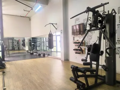 a gym with a cardio machine and weights at Refugio en Barranco, Private Apartament in Barranco in Lima