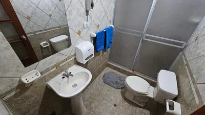 a bathroom with a toilet and a sink at Casa Independiente cerca al Centro en Segundo Piso - Los Profesionales in Cusco