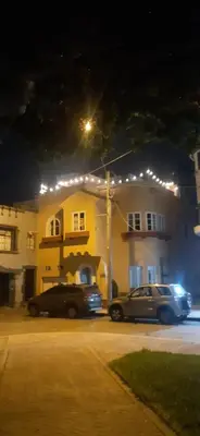 two cars parked in front of a building at night at Quinoa Backpackers Hostel in Lima