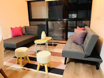 a living room with a couch and a table and chairs at MONTERRICO POLO APARTS #13 - DPTO 2 dorm - Frente Embajada USA in Lima