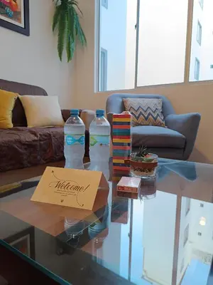 two bottles of water on a glass table in a living room at Runawasi Apartments - José Gonzales 3BDR, near to Larcomar in Lima