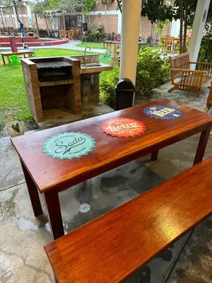 a wooden table with a piano on a patio at La Fogata del Sur in Fundo Copacabana