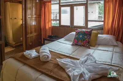 a bedroom with a large bed with towels on it at WARM AND CENTRAL HOUSE WITH SPECTACULAR VIEW OF CUSCO in Cusco