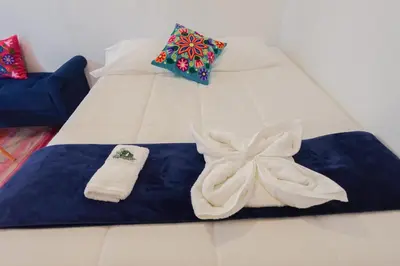 a bed with towels and pillows on it at WARM AND CENTRAL HOUSE WITH SPECTACULAR VIEW OF CUSCO in Cusco