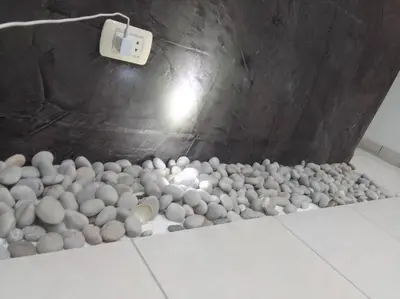 a room filled with gray and white rocks on the floor at Departamento en playa Chocaya. Disfruta del mar, la piscina y la tranquilidad. in Asia