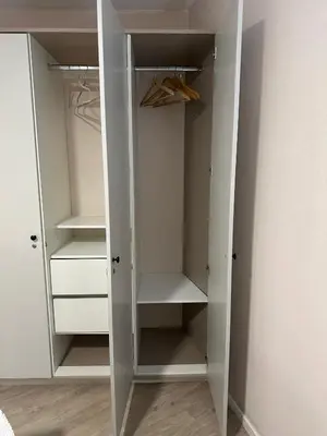 a white closet with white doors and shelves at Friendly Apartment Tamayo in Lima