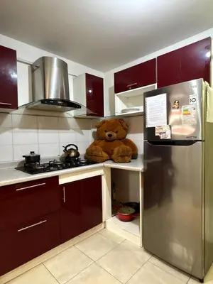 a teddy bear sitting on a counter in a kitchen at Departamento cerca al boulevard in Lima