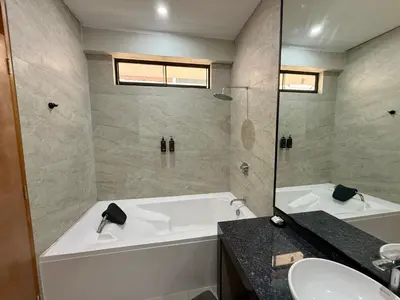 a bathroom with a white tub and a sink at Los Andes - Restaurant & Bungalows in Cieneguilla
