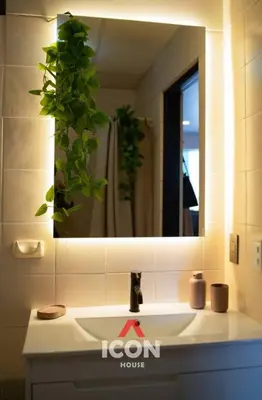 a bathroom sink with a mirror and a plant at Designed Studio in Miraflores / Amazing View in Lima