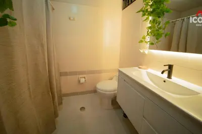 a white bathroom with a toilet and a sink at Designed Studio in Miraflores / Amazing View in Lima