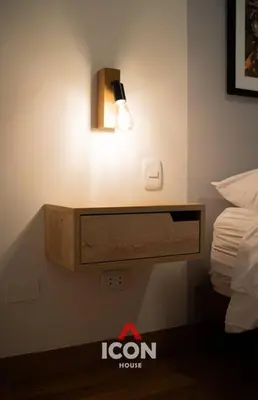 a room with a bed and a light on the wall at Beautiful 2BR in Miraflores in Lima