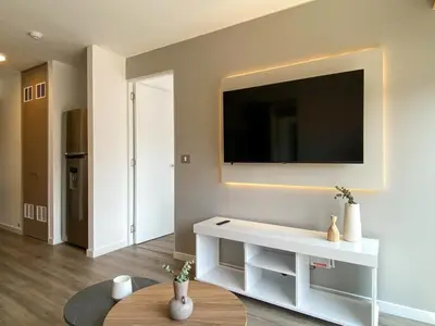 a living room with a flat screen tv on a wall at Los Pinos by Wynwood House in Lima