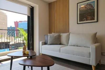 a living room with a couch and a table at Los Pinos by Wynwood House in Lima