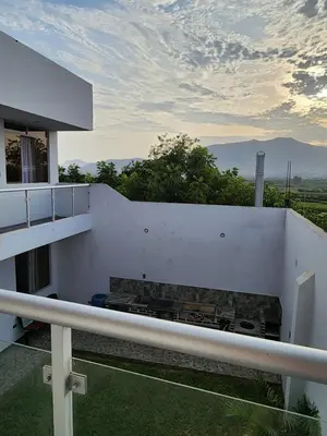 a balcony of a house with a stove at Casa de Campo El Huerto in Lima