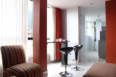 a living room with two chairs and a table at El Peregrino Apart Hotel in Abancay
