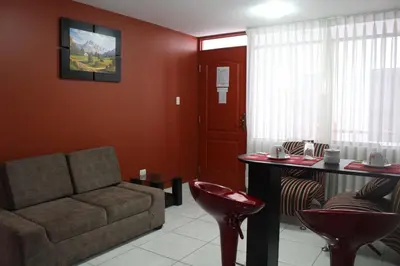 a living room with a couch and a table at El Peregrino Apart Hotel in Abancay