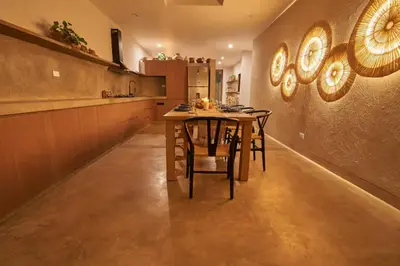 a kitchen with a table and chairs in a room at Relájate en piscina-spa, terraza BBQ y AC Paracas in Paracas