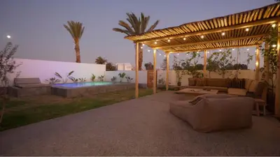 a backyard with a pergola and a pool at Relájate en piscina-spa, terraza BBQ y AC Paracas in Paracas