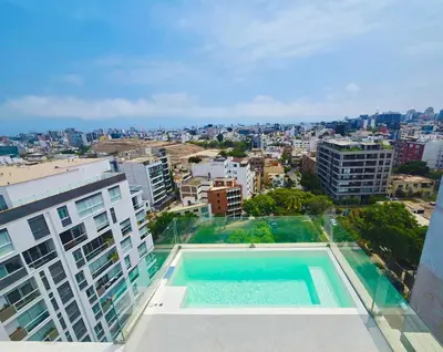 a swimming pool on the roof of a building at Penthouse Luxe private Jacuzzi King AC in Lima
