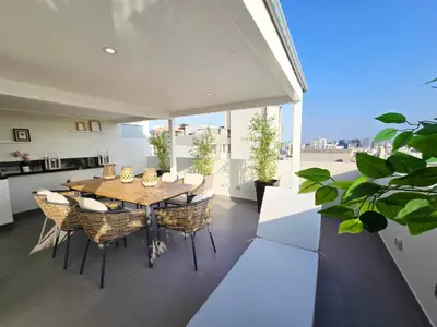 a kitchen and dining room with a table and chairs at Penthouse Luxe private Jacuzzi King AC in Lima