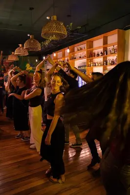 a group of people dancing on a dance floor at Black Llama Hostel Cusco in Cusco