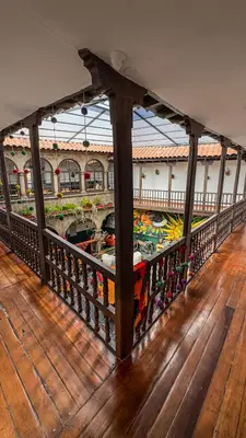 a balcony of a building with boats on the water at Black Llama Hostel Cusco in Cusco