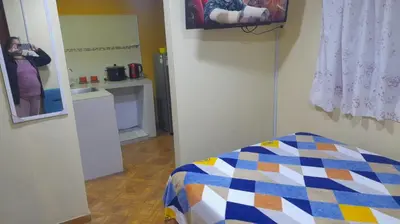 a person taking a picture of a bedroom with a mirror at 202 Comfy Apt WiFi kitchen SmartTV Central at Callao in Lima