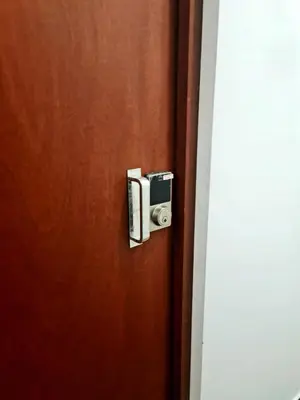 a wooden door with a security camera on it at Dormitorio matrimonial 01 in Lima