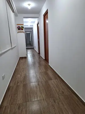 an empty hallway with wood floors and white walls at Dormitorio matrimonial 01 in Lima