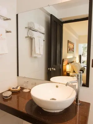 a bathroom with a sink and a large mirror at Hotel Ferré Machu Picchu in Machu Picchu