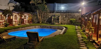a swimming pool in the middle of a yard at night at La Fortaleza del Inca in Lunahuaná