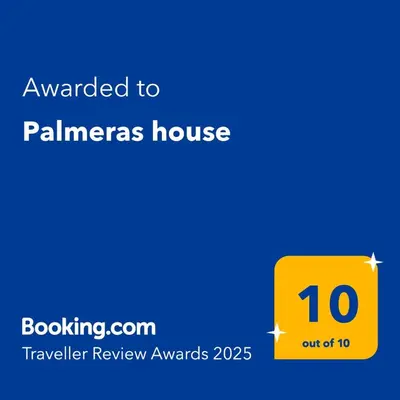 a yellow sign that reads awarded to palmeras house at Palmeras house in Ica