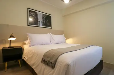 a bedroom with a bed and a lamp on a table at Soul by Wynwood House in Lima