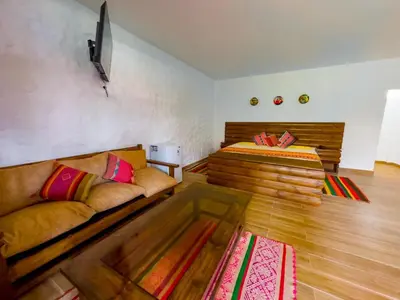 a living room with a couch and a bed at HOTEL RUSTICA CIENEGUILLA in Cieneguilla