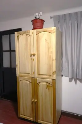a wooden cabinet with a pot on top of it at Millas House Cusco in Cusco