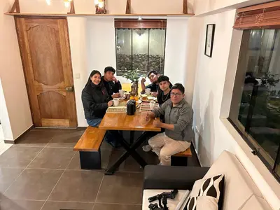 a group of people sitting around a table at Hotel and Country House Valle Sagrado de los Incas in Huaran