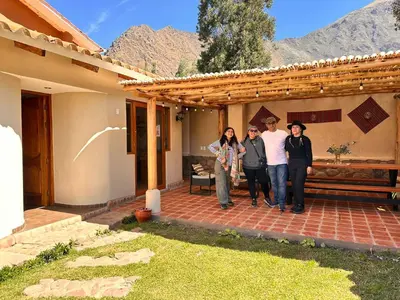 a group of people standing outside of a house at Hotel and Country House Valle Sagrado de los Incas in Huaran