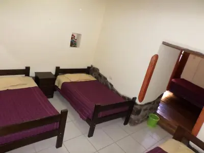 a room with two beds in a room at OkiDoki Cusco Hostal in Cusco