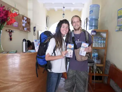 a man and a woman posing for a picture in a store at OkiDoki Cusco Hostal in Cusco