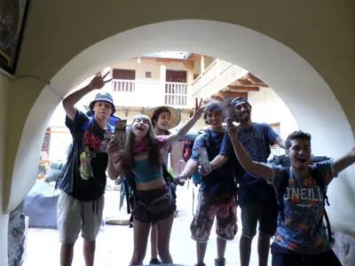 a group of people posing for a picture under an arch at OkiDoki Cusco Hostal in Cusco