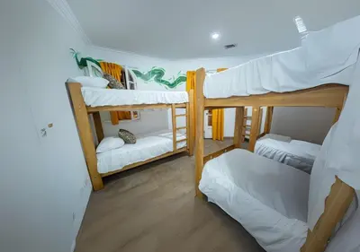 a dorm room with three bunk beds in it at Casa Águila y Cóndor Miraflores in Lima